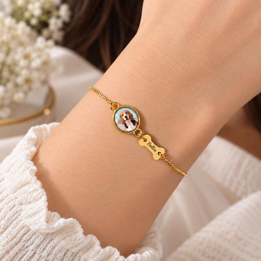 Gold tone pet photo bracelet with a dog photo charm and bone name charm