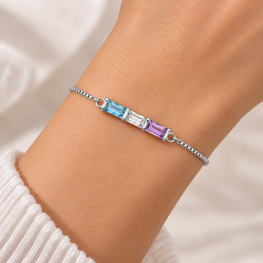 Silver tone baguette birthstone bracelet worn on the wrist