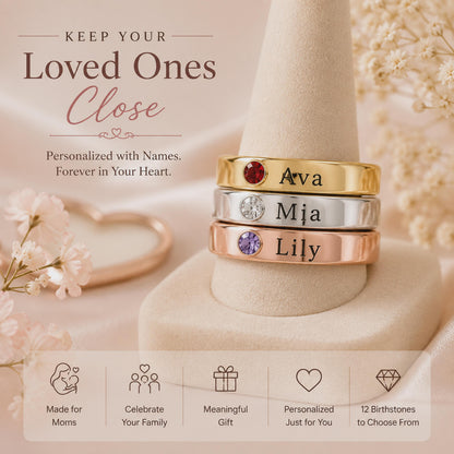 Stack of family birthstone name rings engraved Ava, Mia and Lily