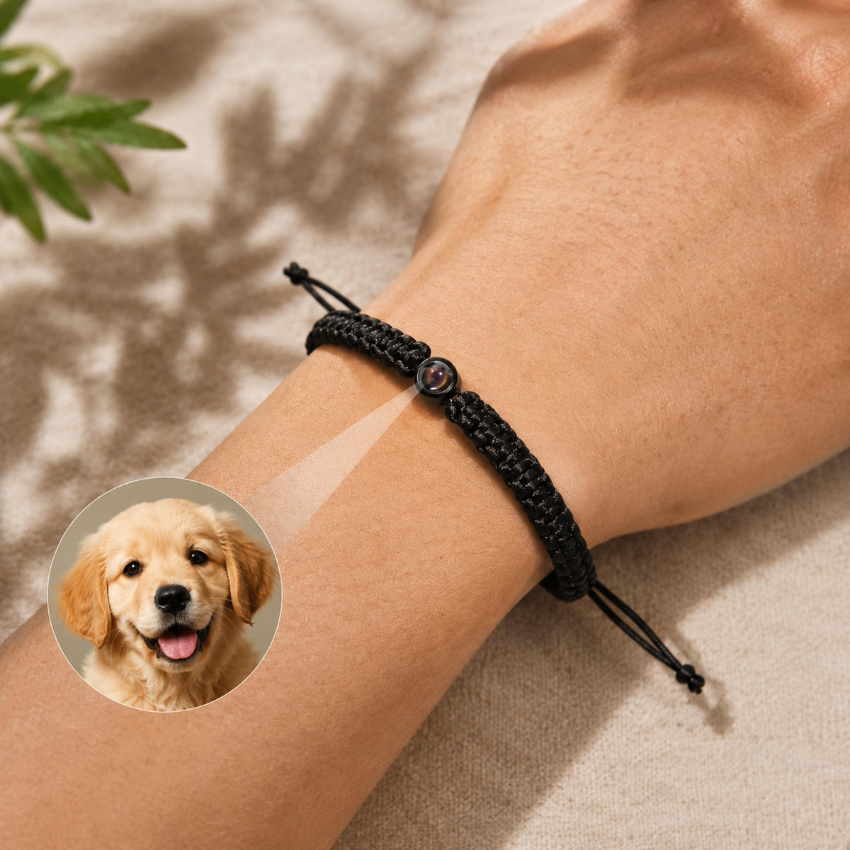 Black braided cord photo projection bracelet with a round charm on the wrist