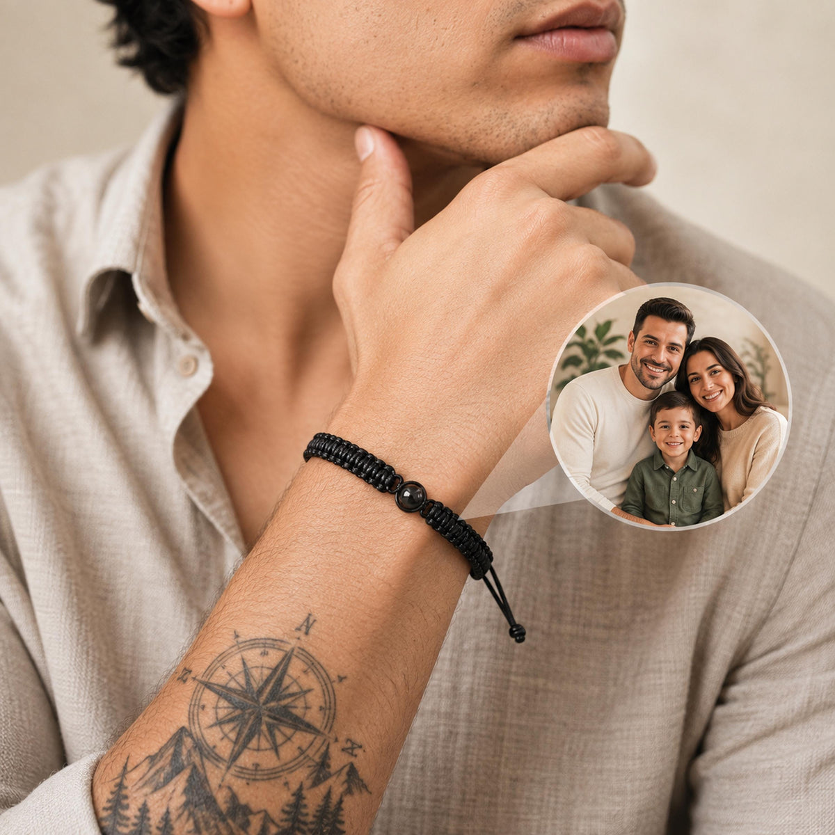 Personalized photo projection bracelet with black braided cord worn on a man's wrist