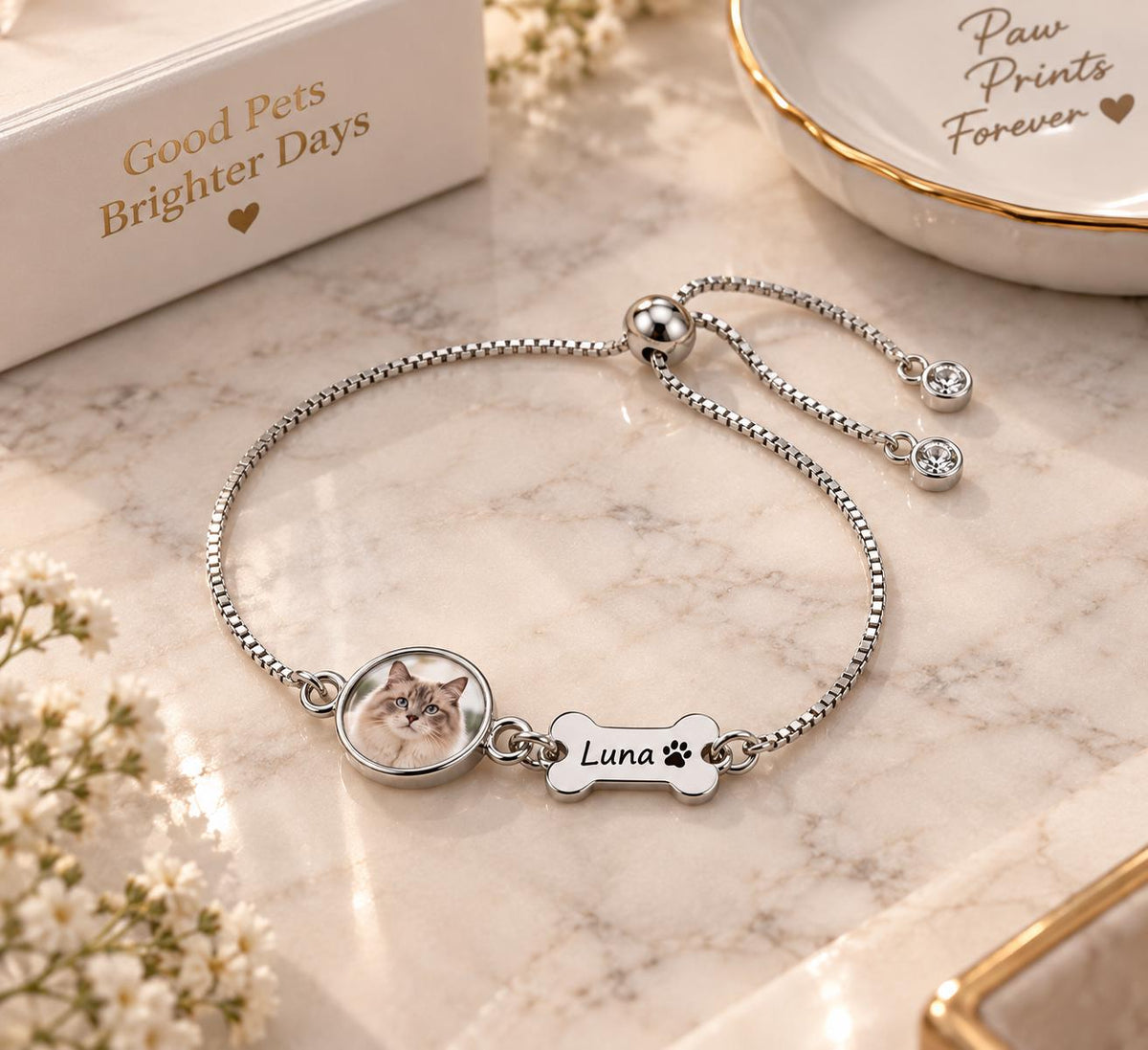 Silver tone pet photo memorial bracelet on a stand