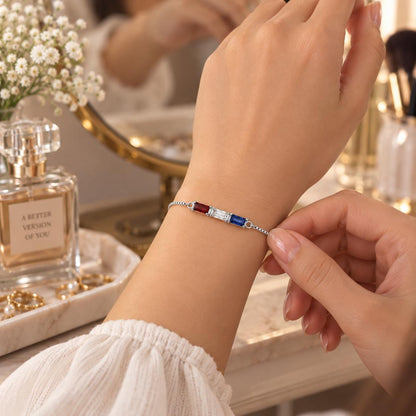 Rose gold tone baguette birthstone bracelet worn on the wrist