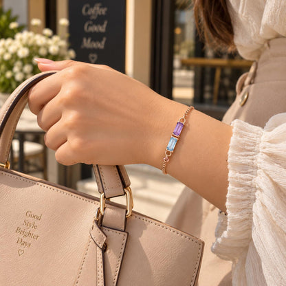 Baguette birthstone bracelet worn on the wrist with a handbag