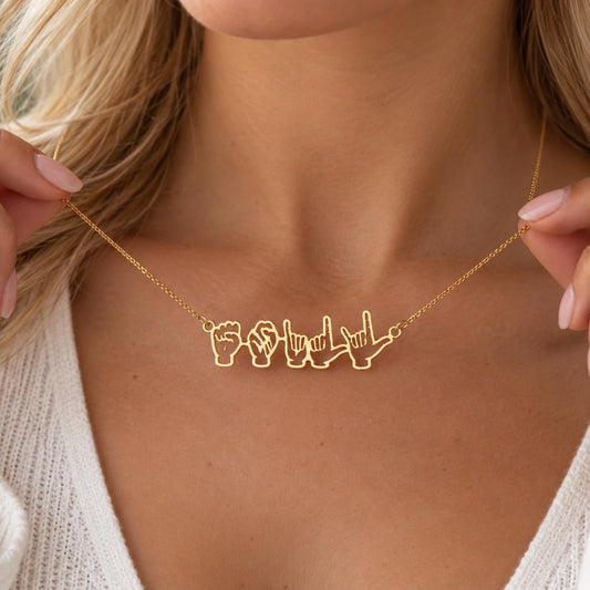 Gold tone sign language name necklace worn on the neck