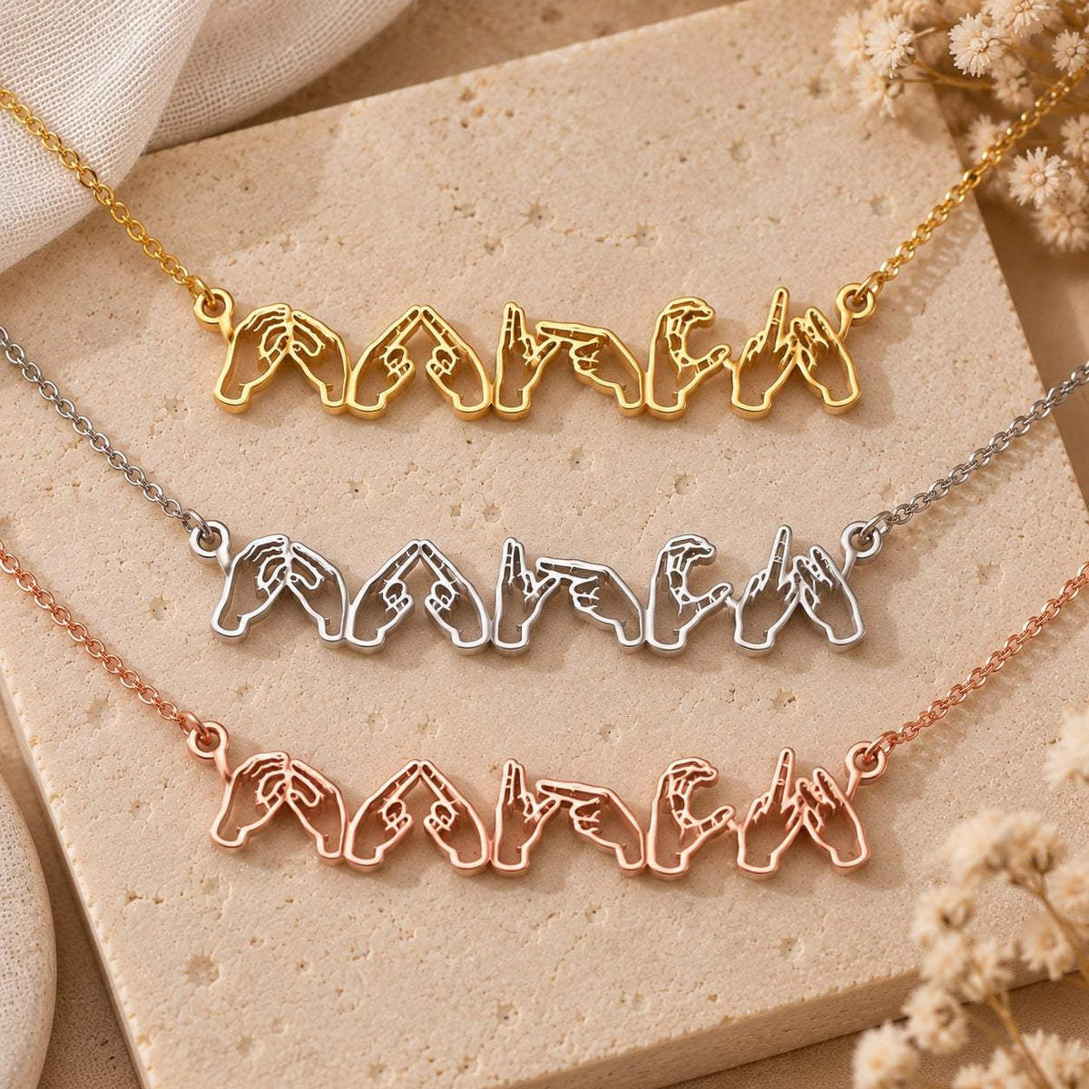 Sign language name necklaces on a stand