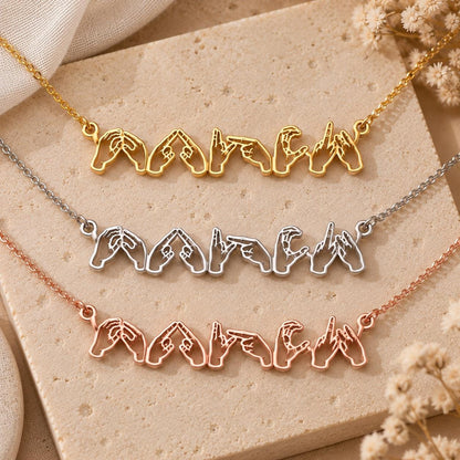 Sign language name necklaces on a stand
