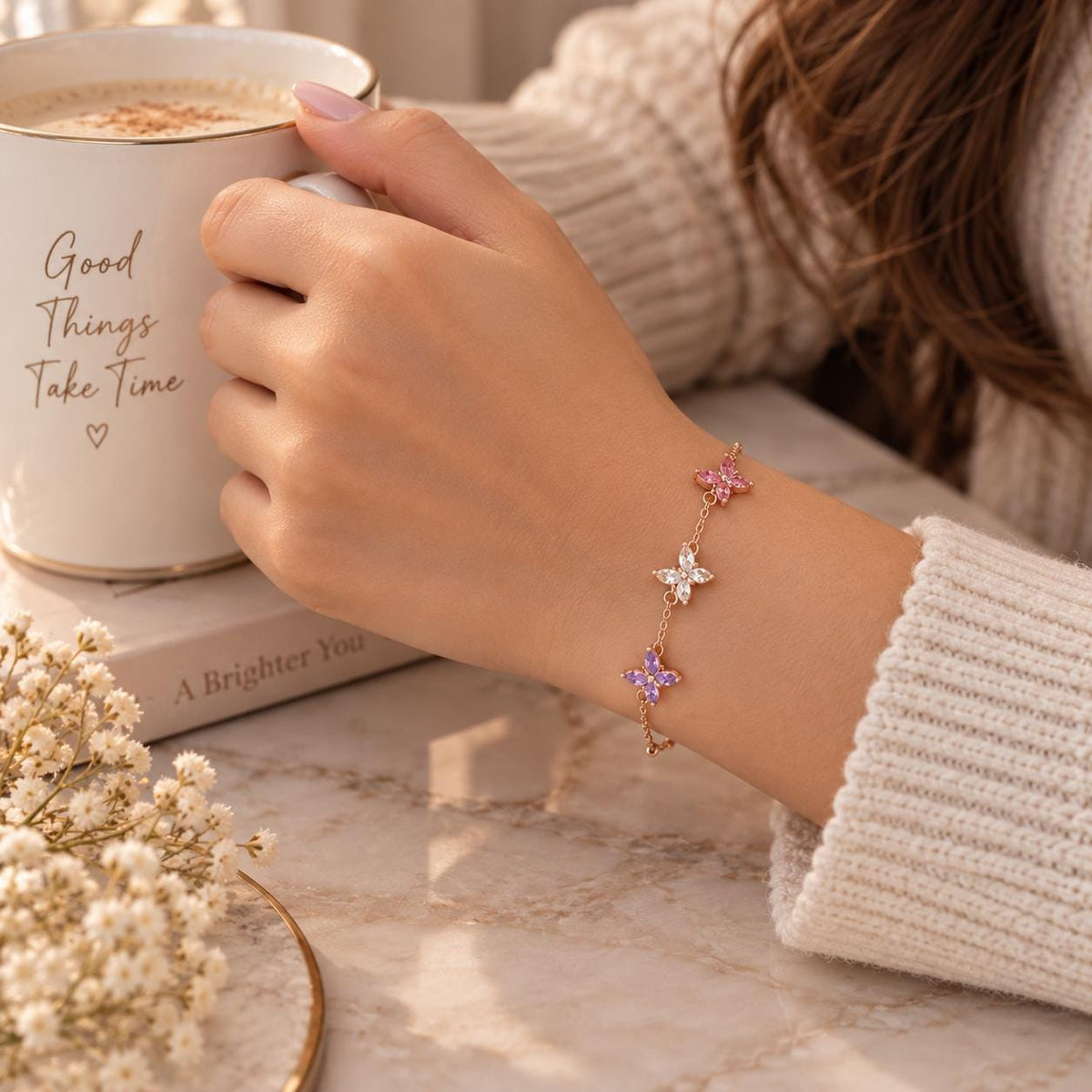 Butterfly birthstone bracelet held in the hand
