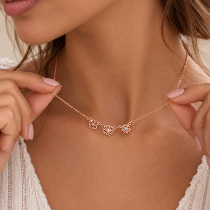 Rose gold tone family birth flower necklace worn on the neck