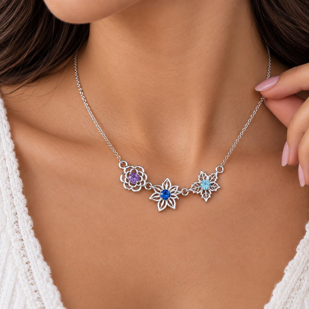 Silver tone family birth flower necklace, close up