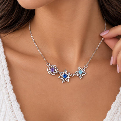 Silver tone family birth flower necklace, close up