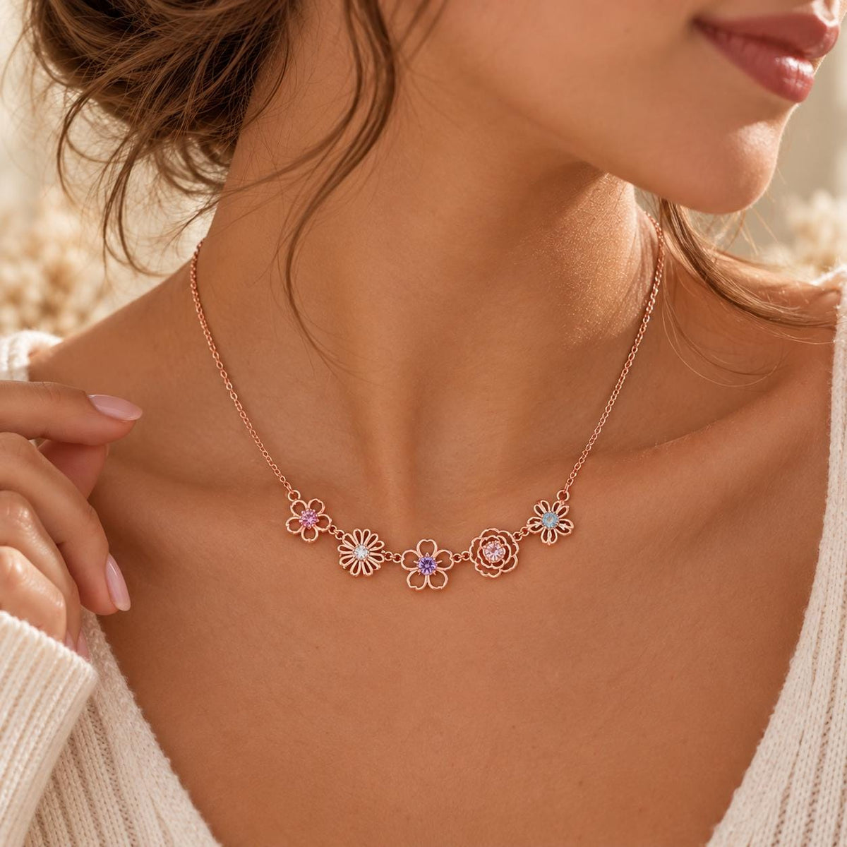 Rose gold tone family birth flower necklace worn on the neck