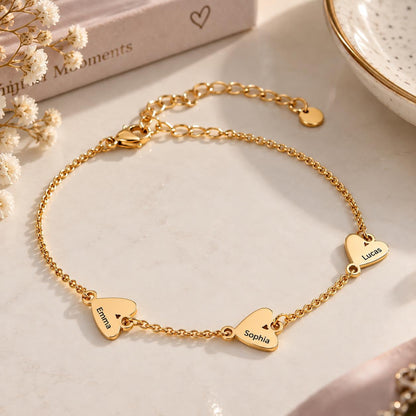 Gold tone heart name bracelet with three engraved hearts