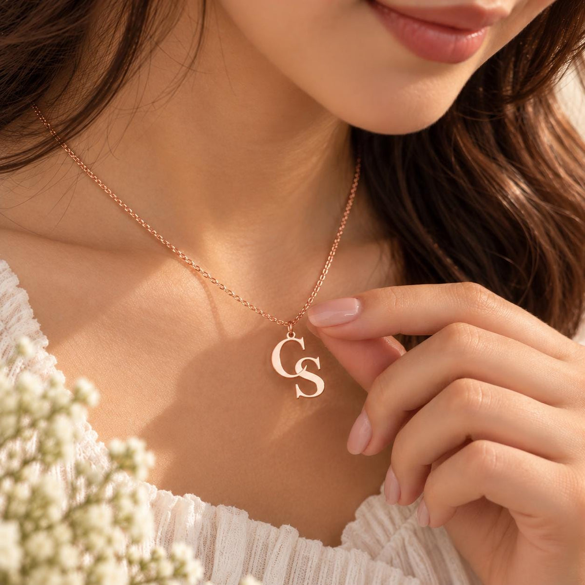 Gold tone double initial necklace worn on the neck