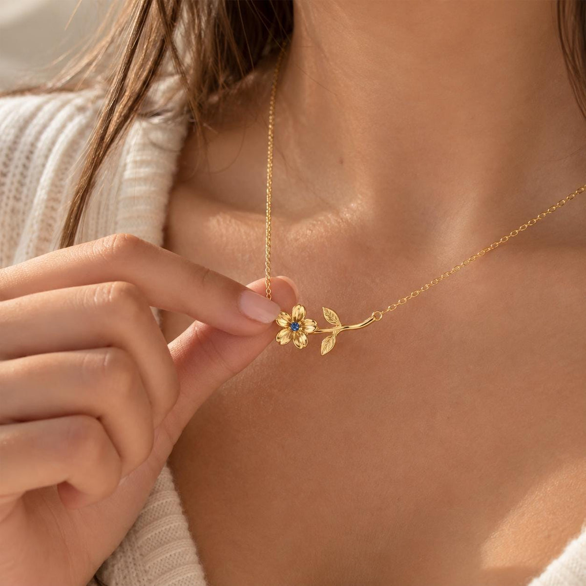 Gold tone birth month flower necklace worn on the neck