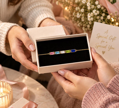 Baguette birthstone bracelet gift box held in the hands