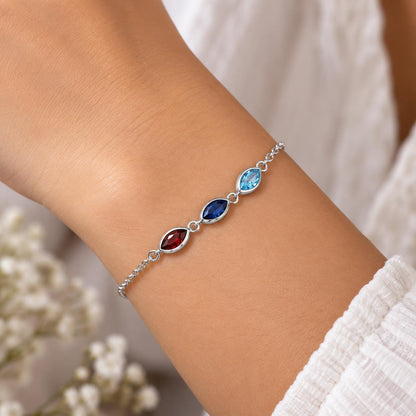 Silver tone leaf birthstone bracelet worn on the wrist