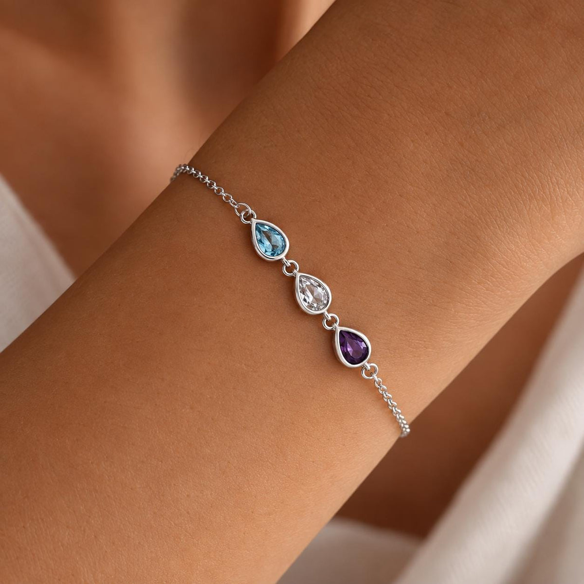 Silver tone leaf birthstone bracelet, close up