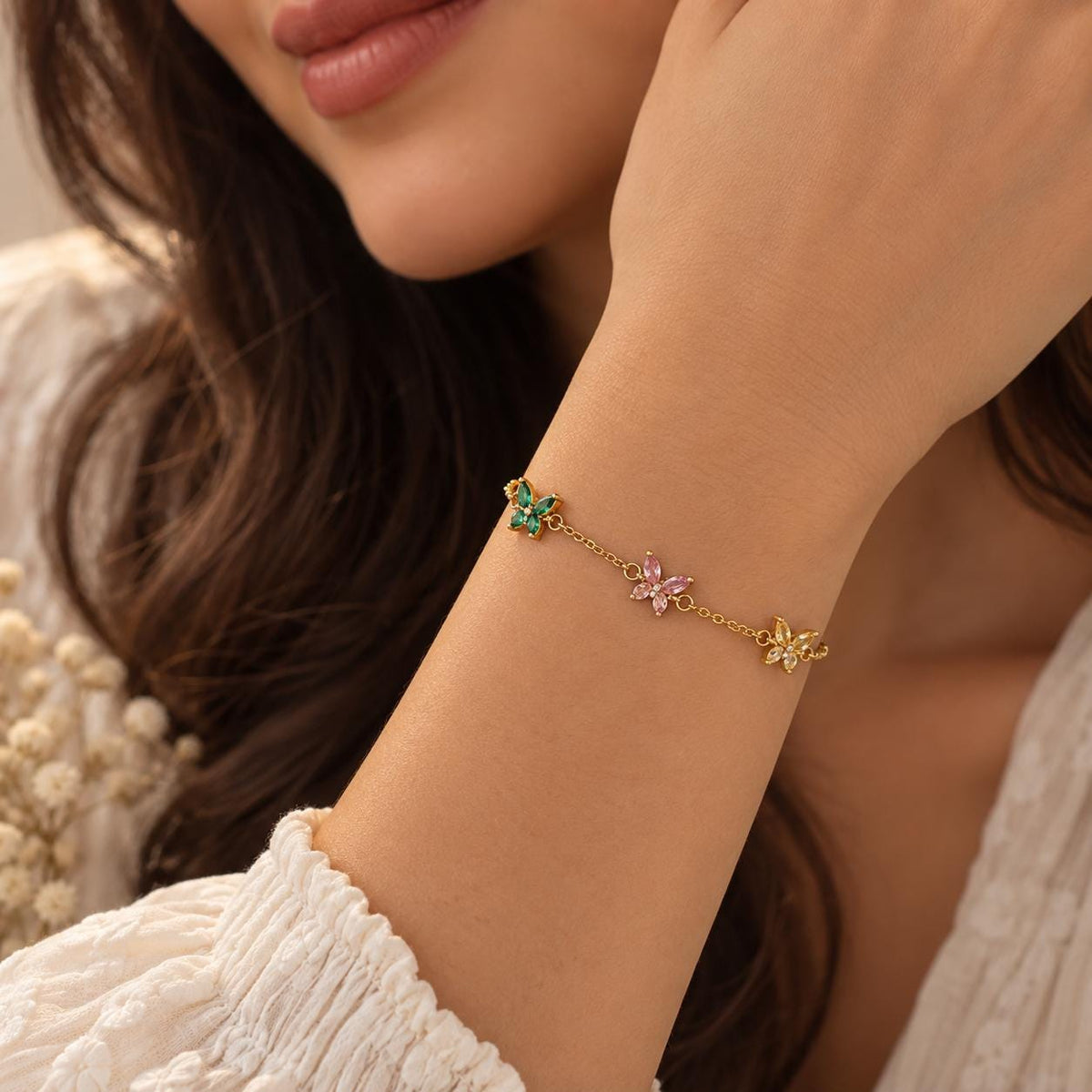 Gold tone butterfly birthstone bracelet worn on the wrist