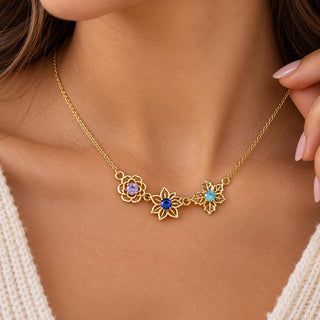 Gold tone family birth flower necklace with birthstone color flowers worn on the neck