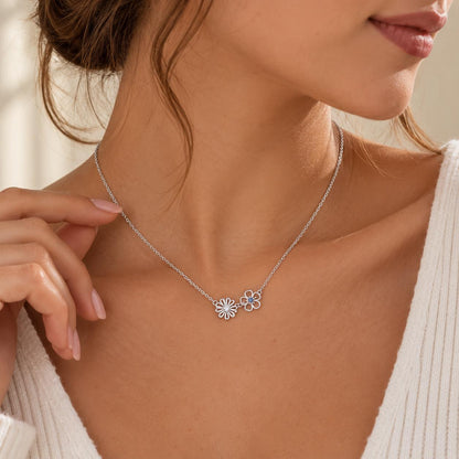 Silver tone family birth flower necklace worn on the neck