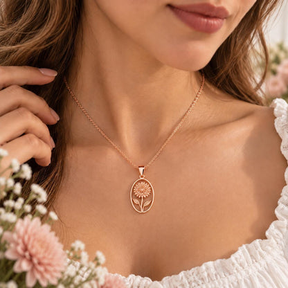 Rose gold tone birth flower necklace worn on the neck