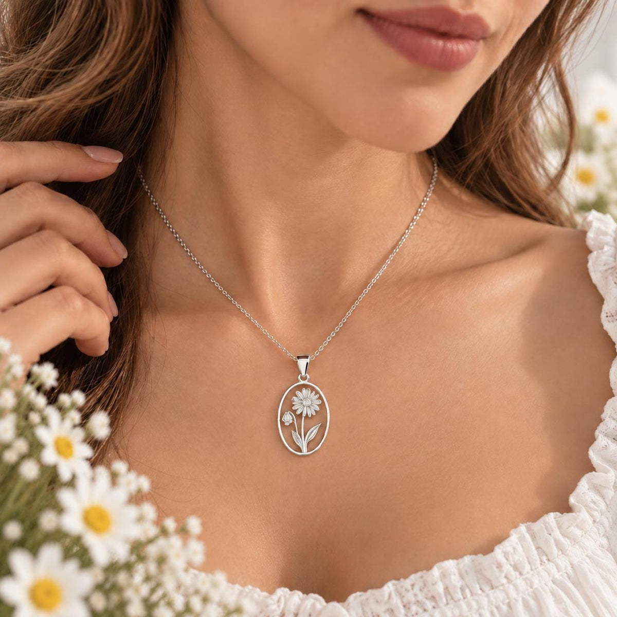 Silver tone birth flower necklace worn on the neck